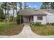 Charming home featuring a covered front porch, landscaped yard, and lovely curb appeal at 8755 Marigold Dr, New Port Richey, FL 34654