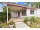 Inviting covered front porch with charming tile flooring, and a colorful exterior trim at 8755 Marigold Dr, New Port Richey, FL 34654
