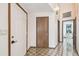 Hallway featuring tiled flooring, access to rooms and laundry room at 8755 Marigold Dr, New Port Richey, FL 34654