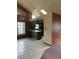 Spacious kitchen with gray wood cabinets, breakfast bar, tile floor, and vaulted ceiling at 8755 Marigold Dr, New Port Richey, FL 34654