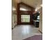 A living room with tiled floors, a large window, and a disco ball chandelier at 8755 Marigold Dr, New Port Richey, FL 34654