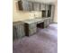 Carpeted office space with a large gray wood look desk and cabinets at 8755 Marigold Dr, New Port Richey, FL 34654