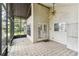 Covered porch featuring tile flooring, ceiling fan, and an exterior entrance with lots of natural light at 8755 Marigold Dr, New Port Richey, FL 34654