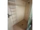 A shower with a built-in rack and pink tile at 8755 Marigold Dr, New Port Richey, FL 34654