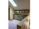 Carpeted area with wet bar, skylight and wood look cabinets at 8755 Marigold Dr, New Port Richey, FL 34654