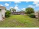 Large, expansive backyard surrounded by a wooden fence, with ample green space at 8850 March Ct, New Port Richey, FL 34655
