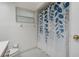 Bathroom featuring a shower-tub combo with a blue and white leafy shower curtain at 8850 March Ct, New Port Richey, FL 34655