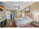 Large primary bedroom with hardwood flooring and access to ensuite bathroom and sitting room at 8850 March Ct, New Port Richey, FL 34655