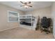 Bedroom with bunk beds featuring storage, ceiling fan, neutral walls, and carpet flooring at 8850 March Ct, New Port Richey, FL 34655