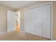 Bright bedroom with a closet and a view into another room with wood flooring at 8850 March Ct, New Port Richey, FL 34655