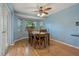 Inviting dining room featuring wood flooring, a bay window, and a modern ceiling fan at 8850 March Ct, New Port Richey, FL 34655