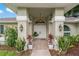 Elegant home entrance with double doors, decorative plants, and modern sconce lighting at 8850 March Ct, New Port Richey, FL 34655