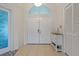 Home foyer featuring tile flooring, double doors, a transom window, and ample storage at 8850 March Ct, New Port Richey, FL 34655