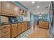 A kitchen with wood cabinets, stainless appliances, and a breakfast nook at 8850 March Ct, New Port Richey, FL 34655