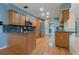Bright kitchen with stainless steel appliances, wood cabinets and flooring, and a granite countertop at 8850 March Ct, New Port Richey, FL 34655