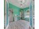 Office space with bright green walls, wood flooring, a large window, and decorative doors at 8850 March Ct, New Port Richey, FL 34655