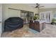 Covered patio with tile flooring, ceiling fan, grill, and outdoor dining set at 8850 March Ct, New Port Richey, FL 34655
