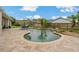Backyard in-ground pool with a brick patio, surrounded by a wooden fence and lush greenery at 8850 March Ct, New Port Richey, FL 34655