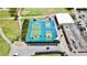 Aerial view of tennis courts and pickleball courts with clubhouse in the background at 9200 Turnberry Ct, New Port Richey, FL 34655