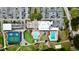 Aerial view of the clubhouse, tennis courts, pools, and putting green at 9200 Turnberry Ct, New Port Richey, FL 34655