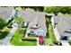 Aerial view of a well-maintained home with mature landscaping and a red car in the driveway at 9200 Turnberry Ct, New Port Richey, FL 34655