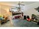 Cozy bedroom with a lofted bed, blue carpet, and whimsical decorations creating a playful atmosphere at 9200 Turnberry Ct, New Port Richey, FL 34655