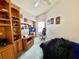 Bedroom featuring built-in shelves, neutral carpet, and a desk area for a functional and comfortable space at 9200 Turnberry Ct, New Port Richey, FL 34655