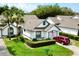 Charming single-story home with manicured lawn, trimmed hedges, and a red car parked in the driveway at 9200 Turnberry Ct, New Port Richey, FL 34655