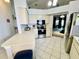Bright kitchen featuring white cabinets, tiled floors, and stainless-steel appliances at 9200 Turnberry Ct, New Port Richey, FL 34655
