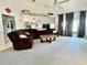 Spacious living room featuring neutral carpet, a large sectional, and sliding glass doors at 9200 Turnberry Ct, New Port Richey, FL 34655