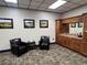 Lounge area with sitting chairs, side table, and wooden cabinets at 9200 Turnberry Ct, New Port Richey, FL 34655
