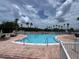 Beautiful outdoor pool surrounded by lush landscaping, creating a relaxing oasis for residents at 9200 Turnberry Ct, New Port Richey, FL 34655