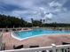 Inviting outdoor pool with lounge chairs and scenic views, perfect for relaxation and recreation at 9200 Turnberry Ct, New Port Richey, FL 34655
