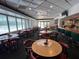 Inviting restaurant interior with tables, chairs, and a bar area, ideal for dining and socializing at 9200 Turnberry Ct, New Port Richey, FL 34655