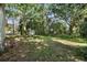 Lush backyard with mature trees offering shade and privacy at 9401 Bourbon St, New Port Richey, FL 34654