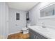 Bathroom featuring sleek vanity, modern fixtures, and laminate flooring at 9401 Bourbon St, New Port Richey, FL 34654