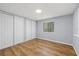This is a well-lit bedroom, featuring a window and two closets, and beautiful laminate flooring at 9401 Bourbon St, New Port Richey, FL 34654