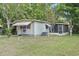 Exterior of a home with screen porch and vibrant green lawn at 9401 Bourbon St, New Port Richey, FL 34654