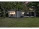 Exterior view of a charming home with a screen porch and well-kept lawn at 9401 Bourbon St, New Port Richey, FL 34654