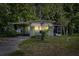 Exterior shot showing a cozy home with an awning and lush greenery at dusk at 9401 Bourbon St, New Port Richey, FL 34654