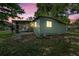 Exterior view of the home at twilight featuring a screened-in porch at 9401 Bourbon St, New Port Richey, FL 34654