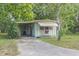 Quaint home featuring carport, awning, and well-maintained landscaping for curb appeal at 9401 Bourbon St, New Port Richey, FL 34654