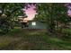 Exterior view of the home at twilight featuring a screened-in porch at 9401 Bourbon St, New Port Richey, FL 34654