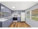 Bright kitchen with new appliances, light countertops and blue-gray cabinetry at 9401 Bourbon St, New Port Richey, FL 34654