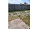 Backyard features a wood fence, a partially tiled patio, and a grassy area at 9516 Glen Moor Ln, Port Richey, FL 34668