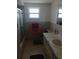 Bathroom featuring a single sink vanity, window, and a shower with glass doors at 9516 Glen Moor Ln, Port Richey, FL 34668