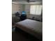 Bedroom featuring a comfortable mattress, ceiling fan, windows, and a desk area at 9516 Glen Moor Ln, Port Richey, FL 34668