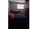 Bedroom with a patterned bedspread, matching tile floor, and a ceiling fan at 9516 Glen Moor Ln, Port Richey, FL 34668