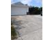 Exterior view of a home featuring a two-car garage and a concrete driveway on a sunny day at 9516 Glen Moor Ln, Port Richey, FL 34668