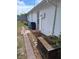 Exterior view of home showcasing the backyard with a brick walkway, greenery, and side entrance at 9516 Glen Moor Ln, Port Richey, FL 34668